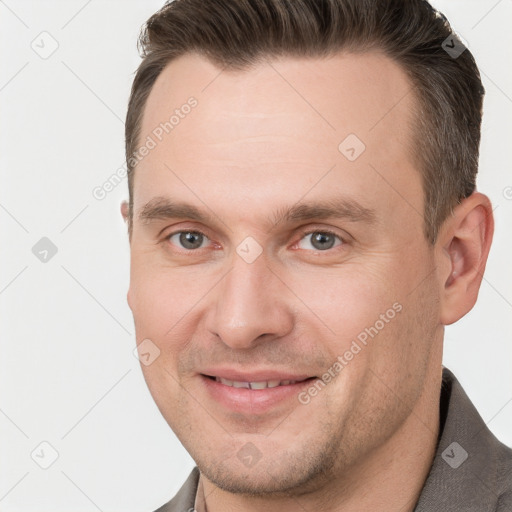 Joyful white adult male with short  brown hair and brown eyes