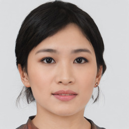 Joyful asian young-adult female with medium  black hair and brown eyes