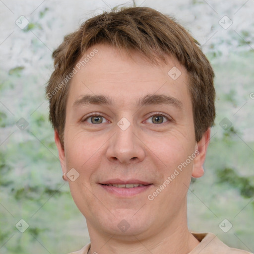 Joyful white adult male with short  brown hair and grey eyes