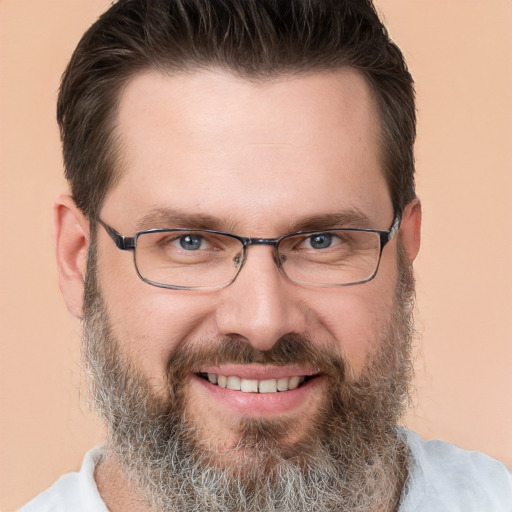 Joyful white adult male with short  brown hair and brown eyes