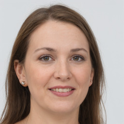 Joyful white young-adult female with long  brown hair and grey eyes