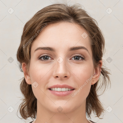 Joyful white young-adult female with medium  brown hair and green eyes