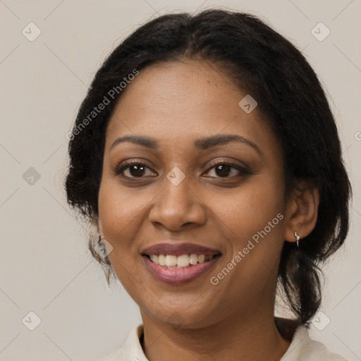 Joyful black adult female with medium  brown hair and brown eyes