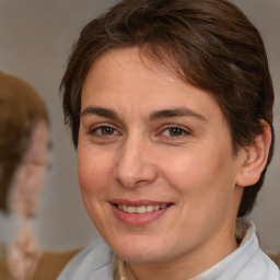 Joyful white adult female with medium  brown hair and brown eyes