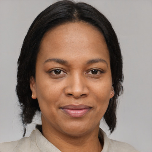 Joyful black young-adult female with medium  brown hair and brown eyes
