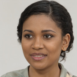 Joyful black young-adult female with medium  brown hair and brown eyes