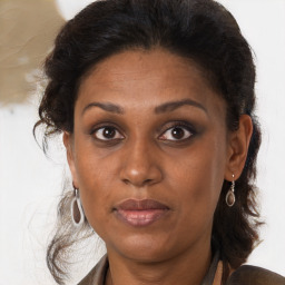 Joyful black adult female with medium  brown hair and brown eyes