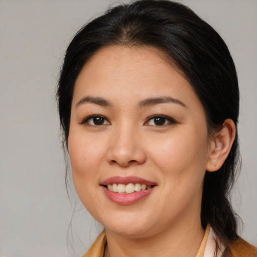 Joyful asian young-adult female with medium  brown hair and brown eyes