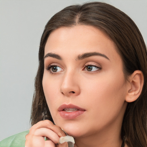 Neutral white young-adult female with long  brown hair and brown eyes