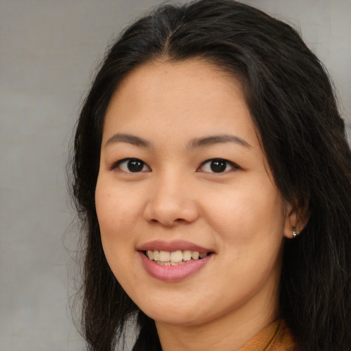Joyful asian young-adult female with long  brown hair and brown eyes