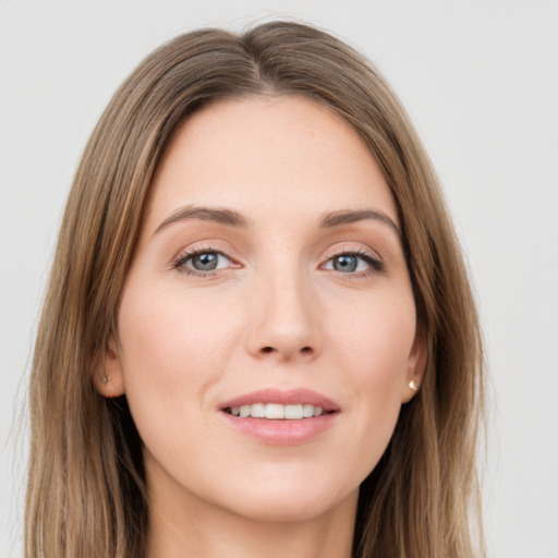 Joyful white young-adult female with long  brown hair and green eyes