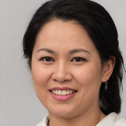 Joyful white young-adult female with medium  brown hair and brown eyes