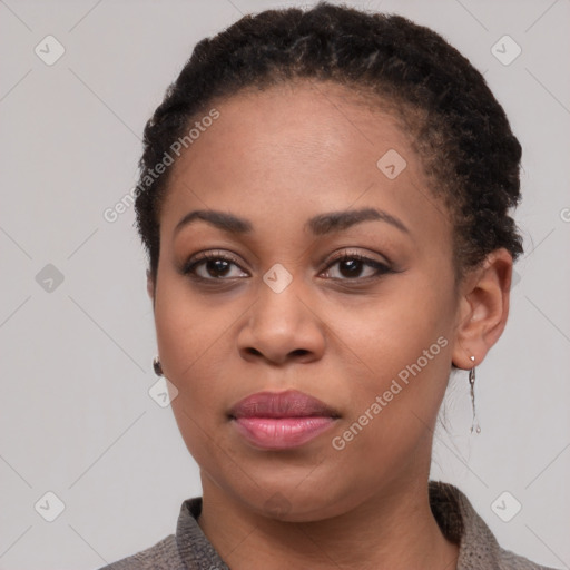 Joyful black young-adult female with short  black hair and brown eyes