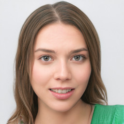 Joyful white young-adult female with medium  brown hair and green eyes