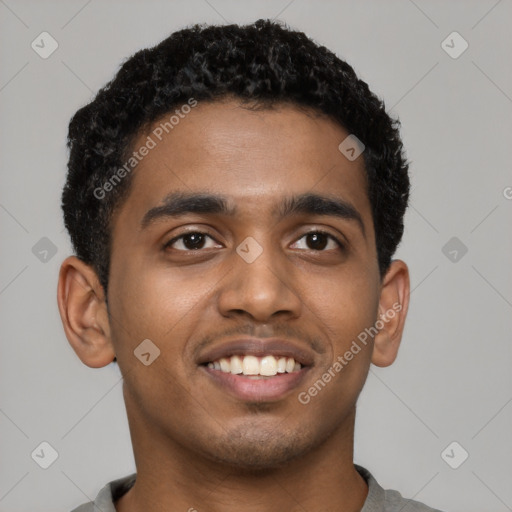 Joyful black young-adult male with short  black hair and brown eyes