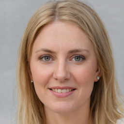 Joyful white young-adult female with long  brown hair and blue eyes