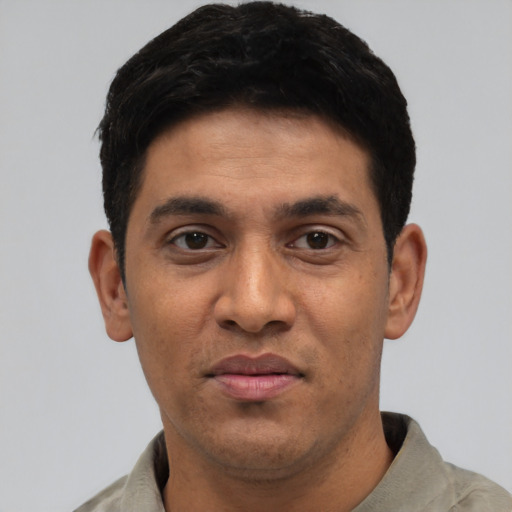 Joyful asian young-adult male with short  black hair and brown eyes