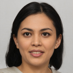 Joyful latino young-adult female with medium  brown hair and brown eyes