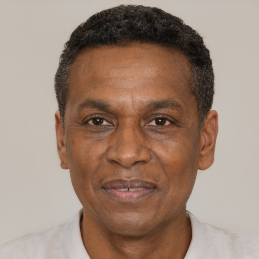 Joyful black adult male with short  black hair and brown eyes