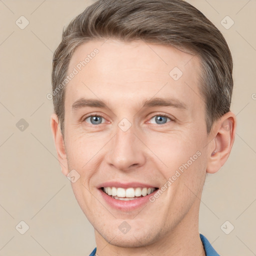 Joyful white adult male with short  brown hair and grey eyes