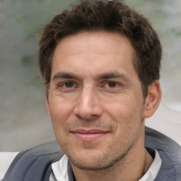 Joyful white adult male with short  brown hair and brown eyes