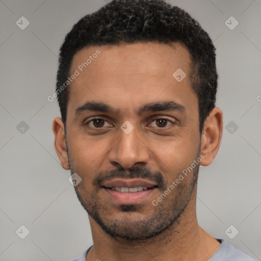 Joyful latino young-adult male with short  black hair and brown eyes