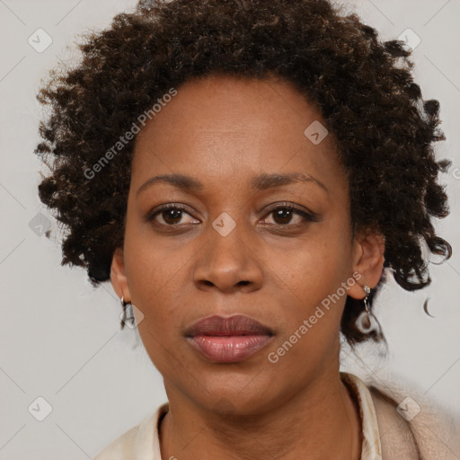 Joyful black adult female with short  brown hair and brown eyes