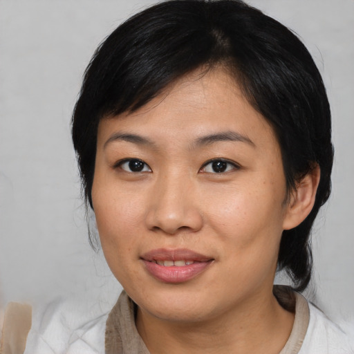 Joyful asian young-adult female with medium  black hair and brown eyes