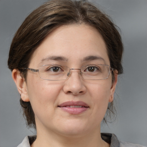 Joyful white adult female with medium  brown hair and grey eyes