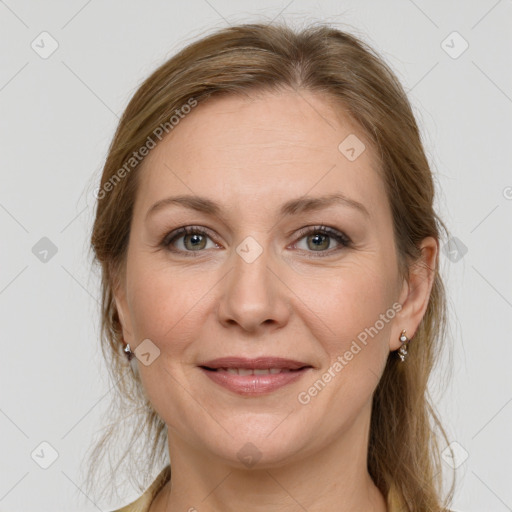 Joyful white adult female with long  brown hair and grey eyes