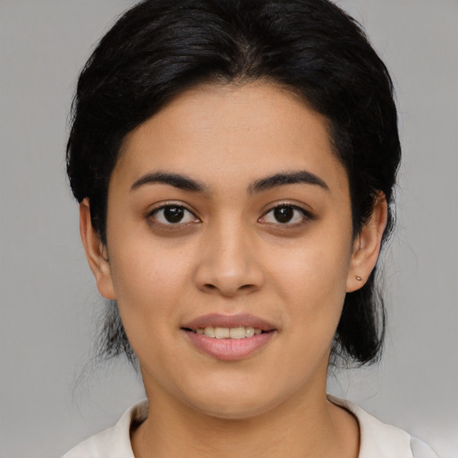 Joyful latino young-adult female with medium  black hair and brown eyes