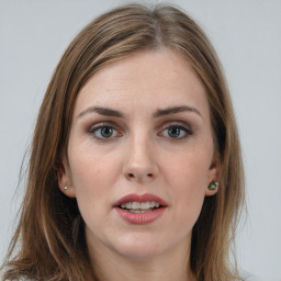 Joyful white young-adult female with long  brown hair and grey eyes