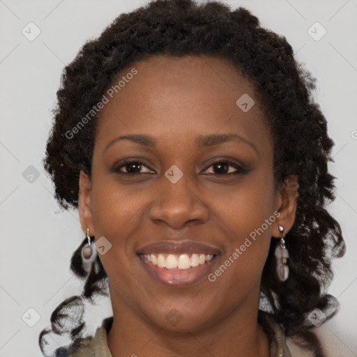 Joyful black adult female with long  brown hair and brown eyes