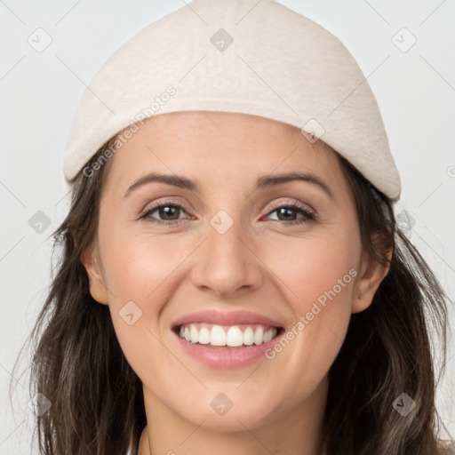 Joyful white young-adult female with long  brown hair and grey eyes