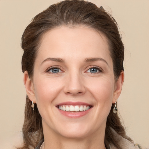 Joyful white young-adult female with long  brown hair and grey eyes