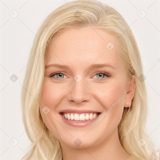 Joyful white young-adult female with long  blond hair and blue eyes