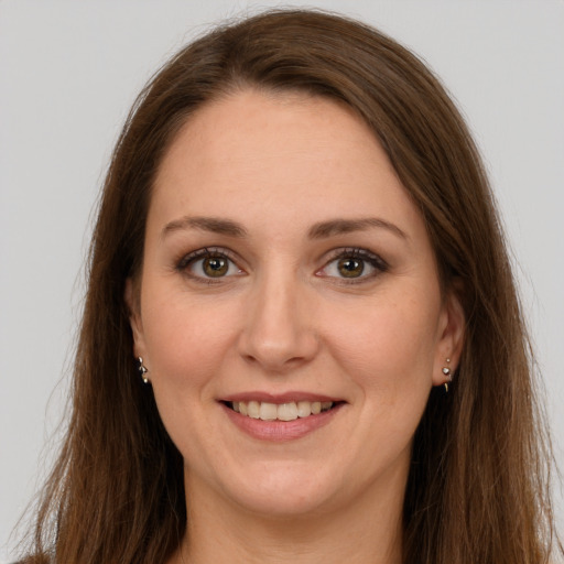 Joyful white adult female with long  brown hair and grey eyes