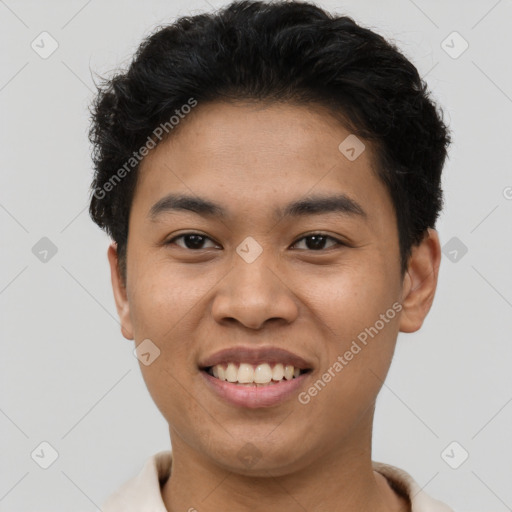 Joyful latino young-adult male with short  brown hair and brown eyes