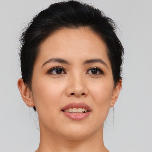 Joyful asian young-adult female with short  brown hair and brown eyes