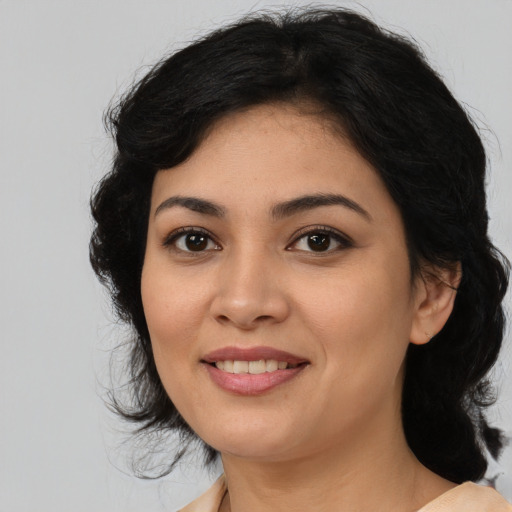 Joyful latino young-adult female with medium  black hair and brown eyes