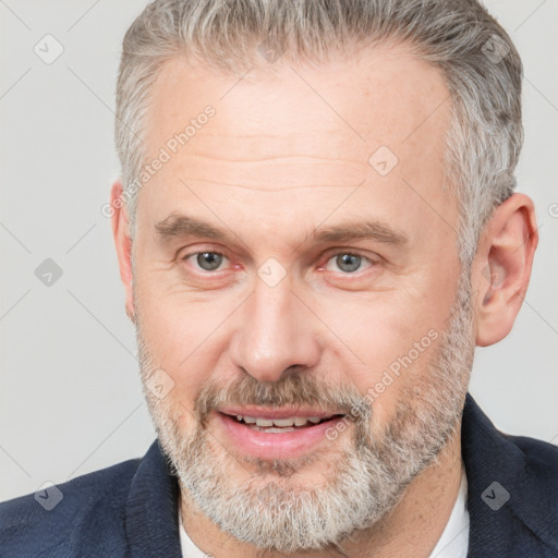 Joyful white middle-aged male with short  brown hair and brown eyes