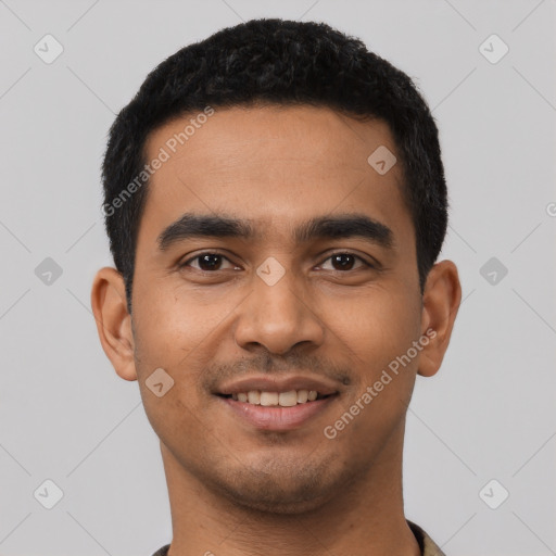 Joyful latino young-adult male with short  black hair and brown eyes