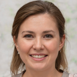 Joyful white young-adult female with medium  brown hair and grey eyes