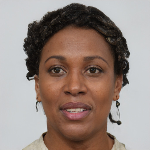 Joyful black adult female with short  brown hair and brown eyes
