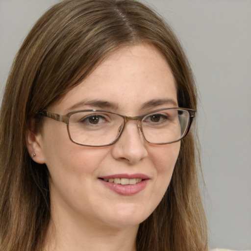 Joyful white adult female with long  brown hair and blue eyes