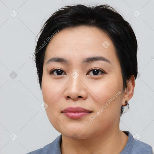 Joyful asian young-adult female with medium  black hair and brown eyes