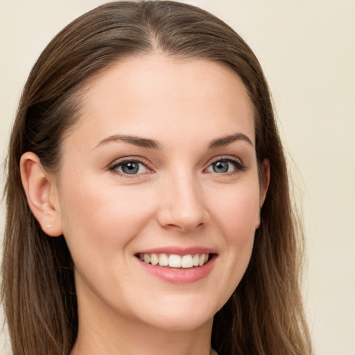 Joyful white young-adult female with long  brown hair and grey eyes