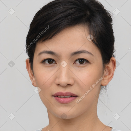 Joyful asian young-adult female with short  brown hair and brown eyes