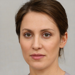 Joyful white young-adult female with medium  brown hair and green eyes