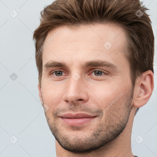 Joyful white young-adult male with short  brown hair and brown eyes